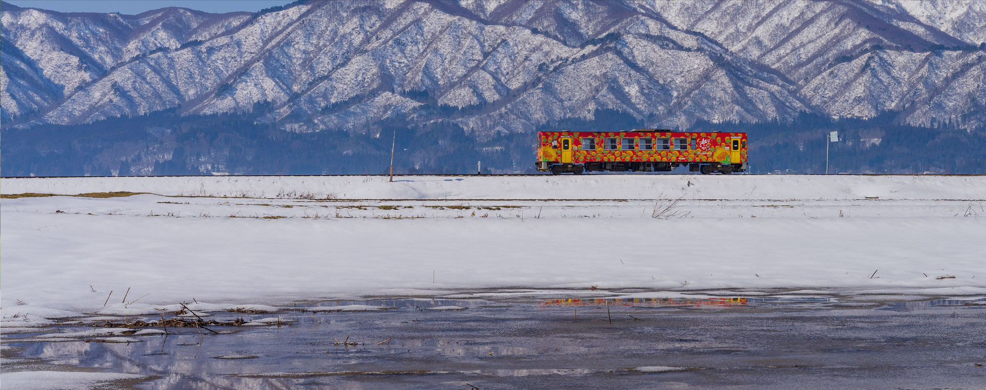 雪景色の中を走るフラワー長井線